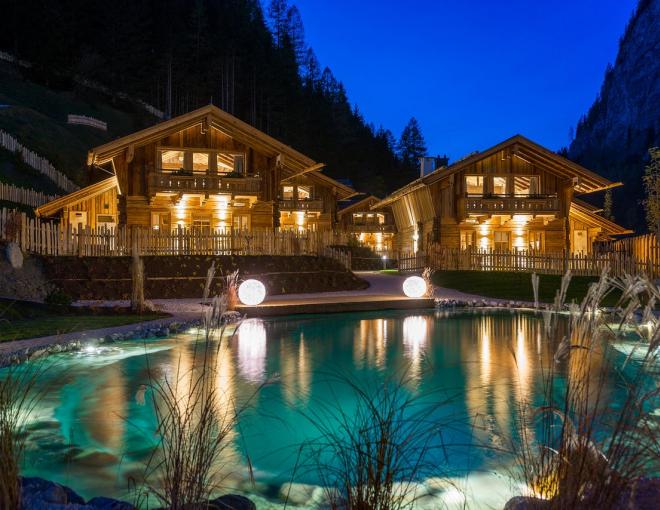 Aussenansicht des Badeteiches und der Unterkunft im Chaletdorf Auszeit
